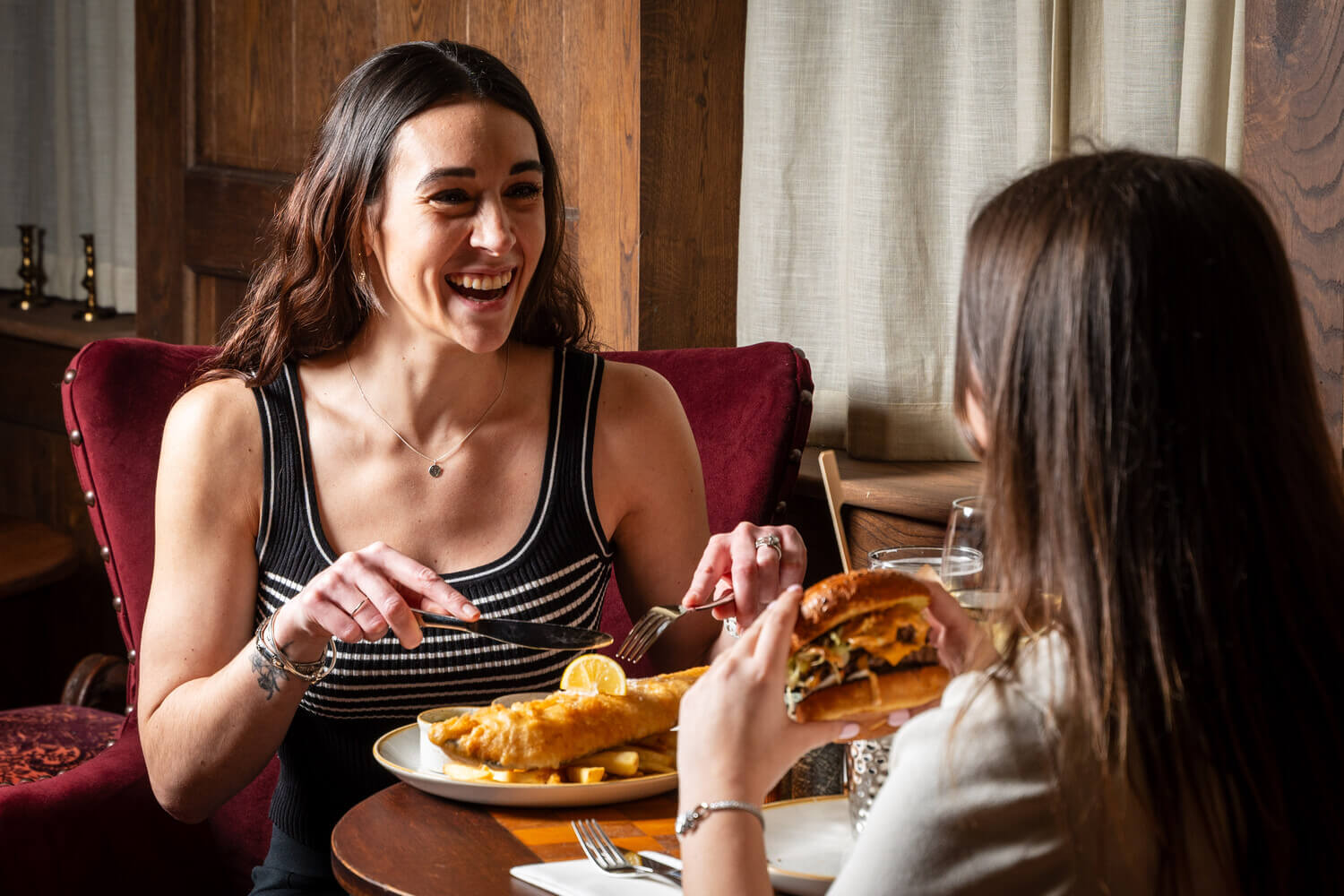 Two people eating in Hoop & Grapes Shepherd Neame pub in Farringdon, London